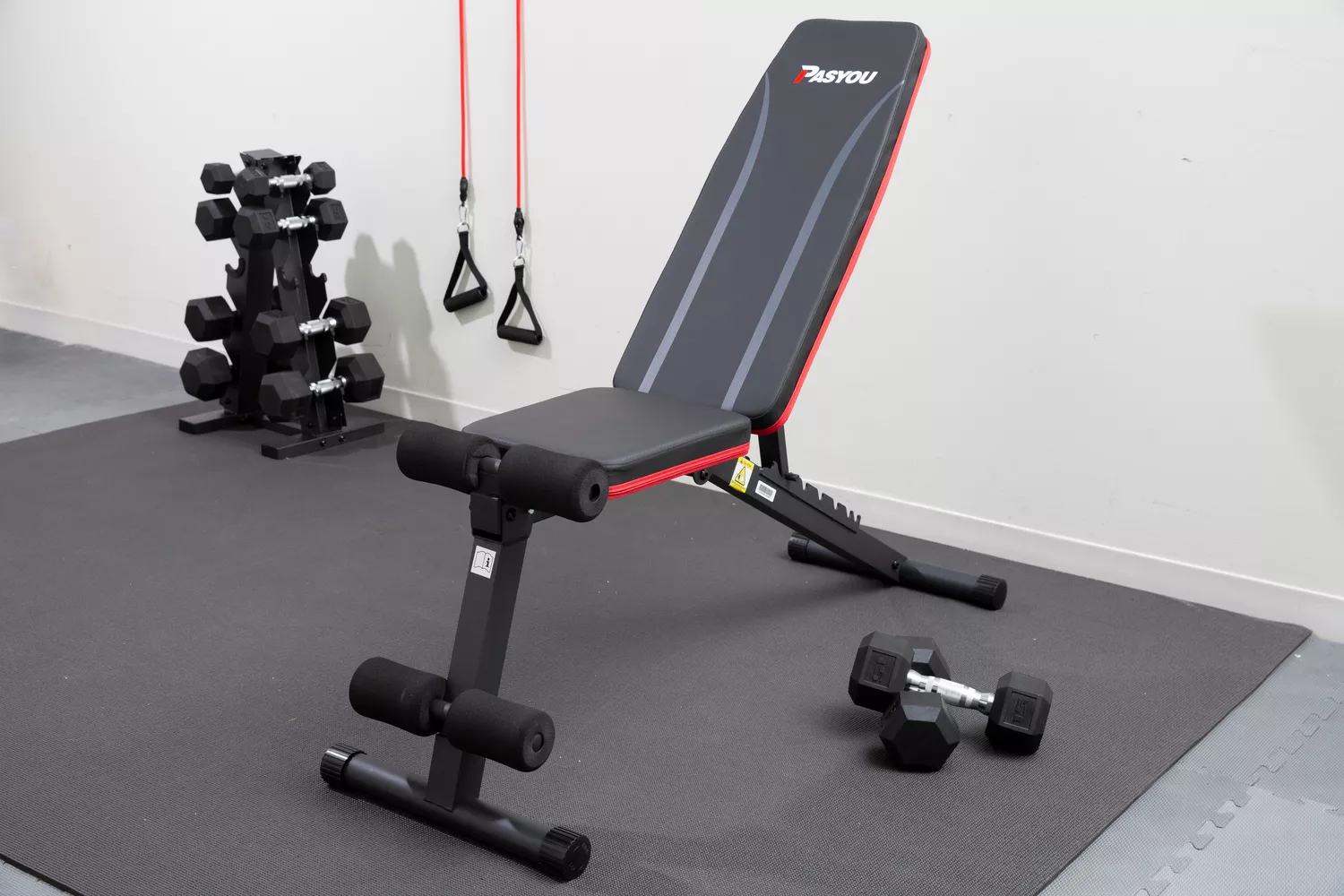 PASYOU Adjustable Weight Bench on mat with exercise equipment 