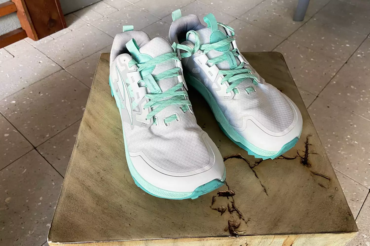 Altra Women's Lone Peak 7 Trail Running Shoes displayed on a wooden block