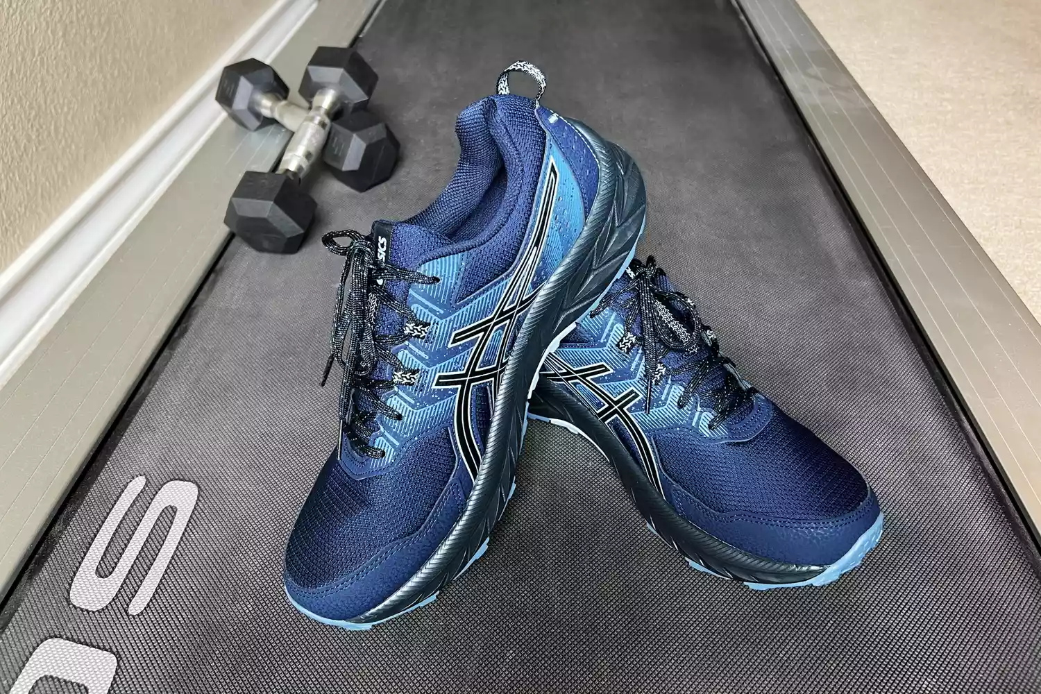 ASICS Women's Gel-Venture 9 Running Shoes displayed next to weights on a treadmill 